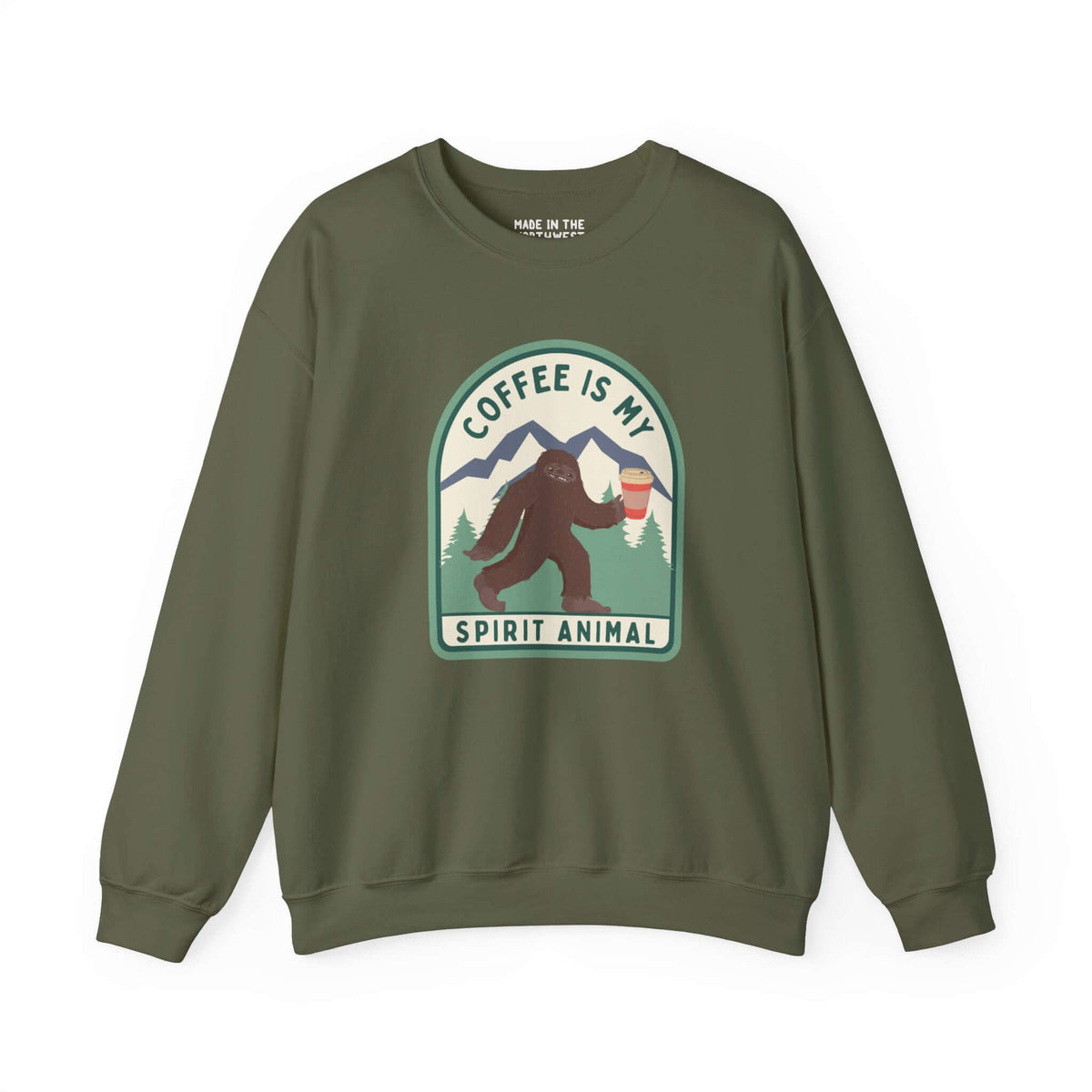 Green sweatshirt featuring Sasquatch with coffee cup, text "Coffee Is My Spirit Animal," ideal for coffee lovers and forest vibes.