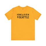 Home Is in Seattle Tee in vibrant yellow, showcasing Seattle pride with graphic elements like a campfire and evergreen.