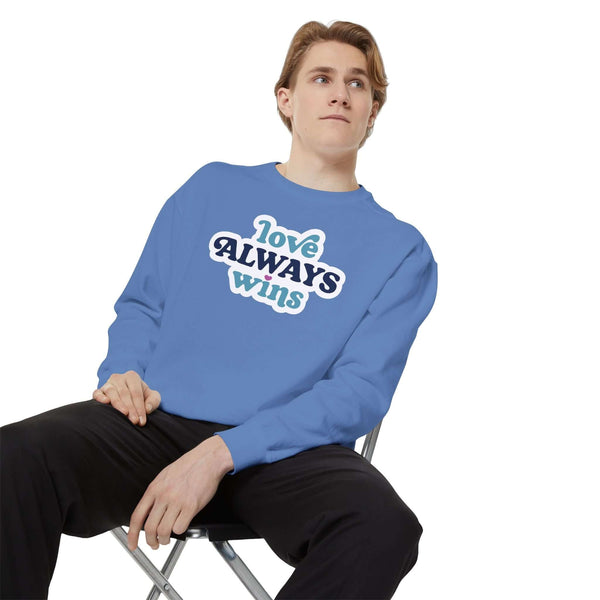 love always wins sweatshirt on a model, showcasing cozy and positive comfort in a blue color.