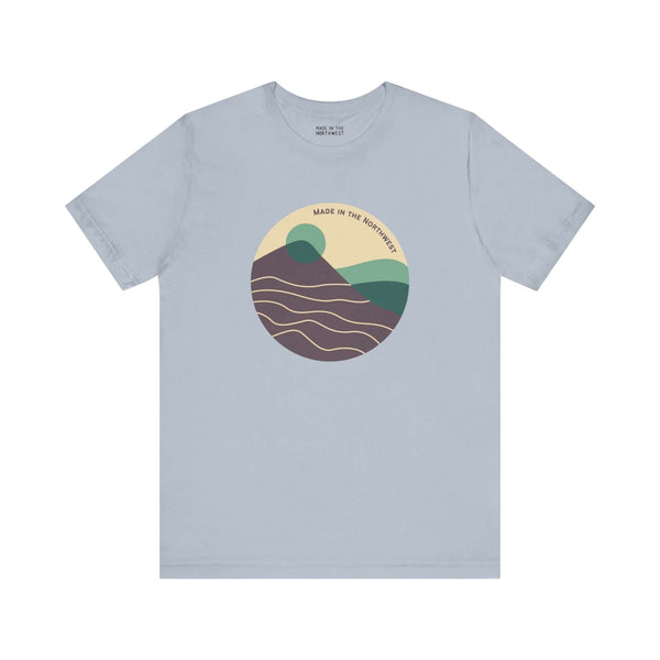 Pacific Peaks Modern Circle Soft Tee with mountain scene design in muted colors, showcasing Pacific Northwest beauty.