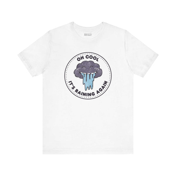 Oh Cool It's Raining Again T Shirt featuring a storm cloud and raindrops design on a white background.