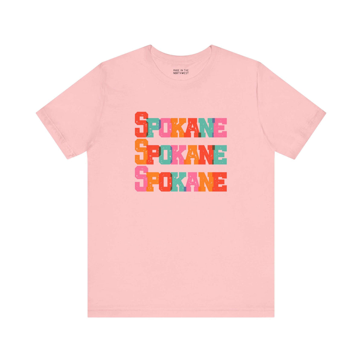 Pink Spokane t-shirt with colorful block-letter design, featuring "Spokane" stacked in bold hues, perfect for Lilac City fans.