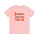 Pink Spokane t-shirt with colorful block-letter design, featuring 