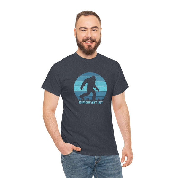 Man wearing Squatchin' Ain't Easy athletic tee featuring a Bigfoot graphic in a circular design.