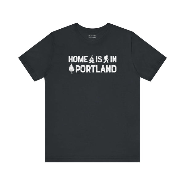 Home Is in Portland Tee – Rose City Pride Shirt featuring campfire, tree, and Bigfoot illustrations.