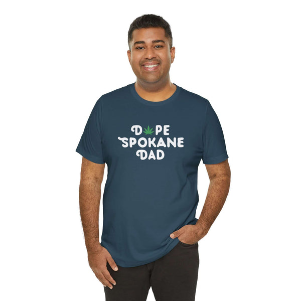Man wearing a Dope Spokane Dad soft tee featuring a marijuana leaf in the design, showcasing local pride.