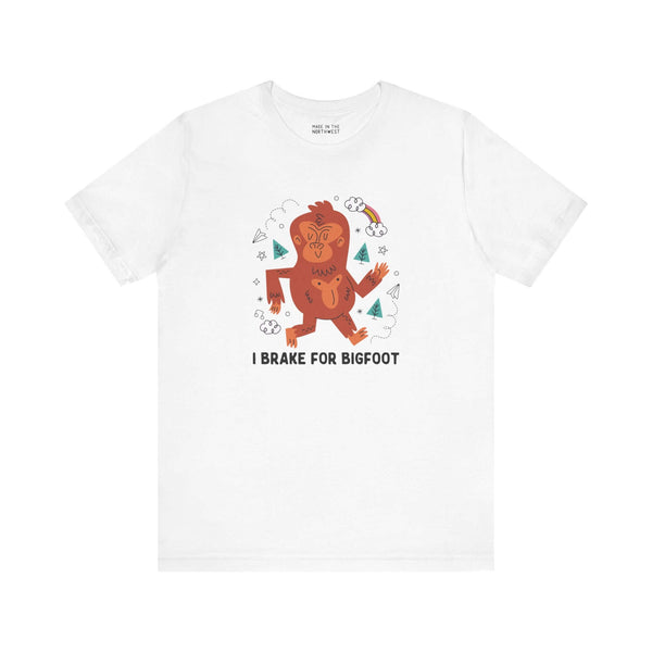 I Brake for Bigfoot Soft Tee Show your playful side and love for local folklore with our "I Brake for Bigfoot" Sasquatch Tee. This fun design features the phrase "I Brake for Bigfoot" alongside a whimsical graphic of a Sasquatch, perfect for those who enj