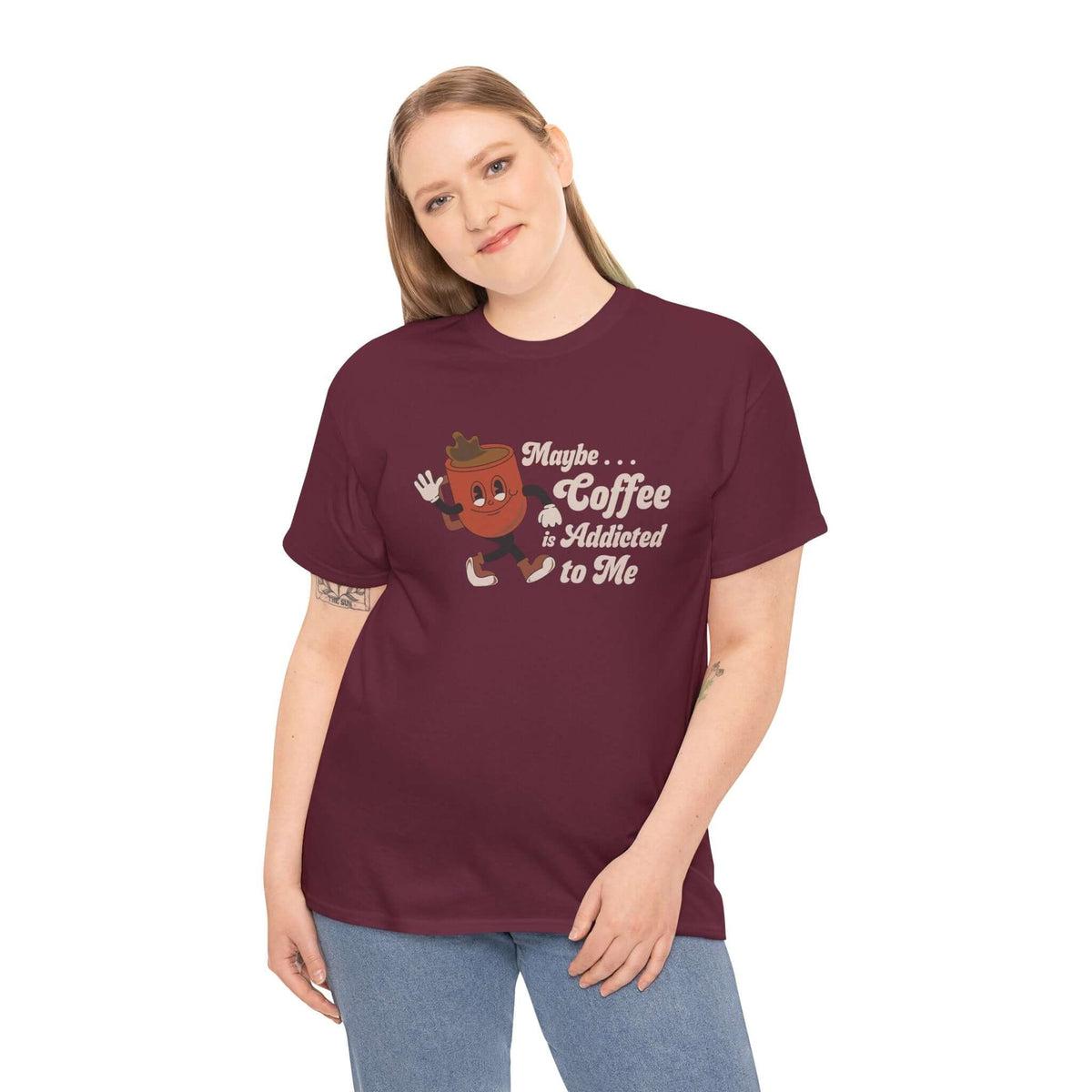 Woman wearing 'Maybe Coffee is Addicted to Me' athletic tee with playful coffee design, maroon color.