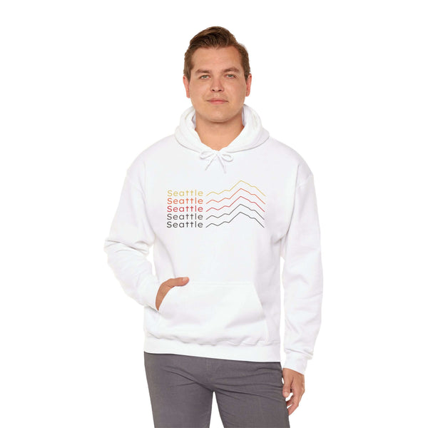 Man wearing Seattle Minimalist Mountain Hoodie with stacked mountain design in mid-century colors.