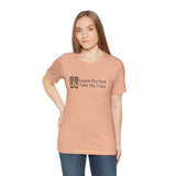 Woman wearing Leave the Road, Take the Trails soft tee, celebrating outdoor adventures and unpaved paths.