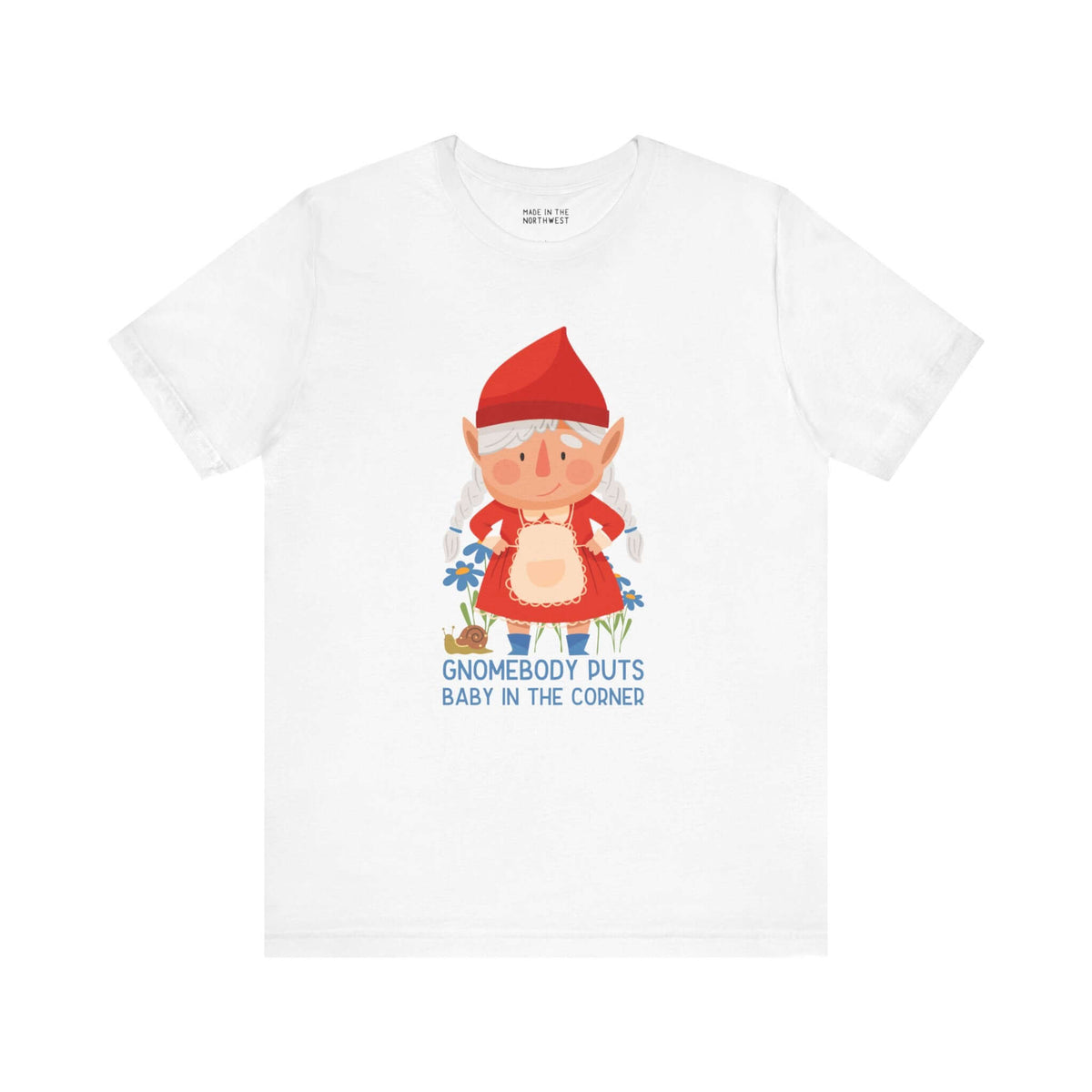 White tee featuring a cute female gnome with the text "Gnomebody Puts Baby in the Corner," inspired by a classic movie line.