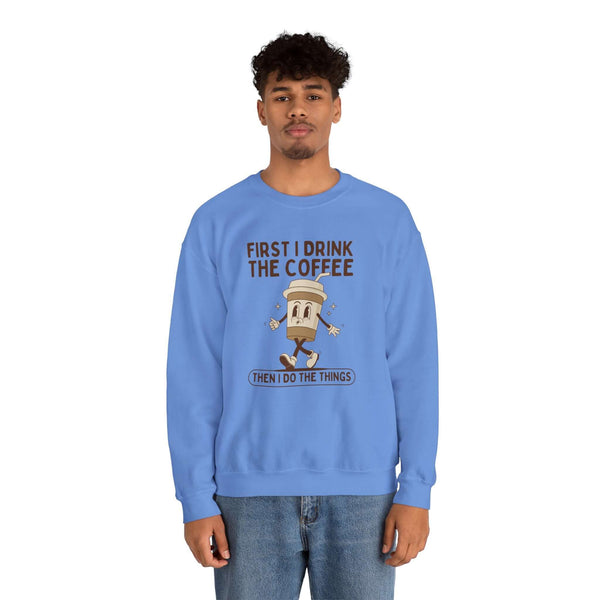 Blue sweatshirt with 'First I Drink the Coffee Then I Do the Things' graphic design.
