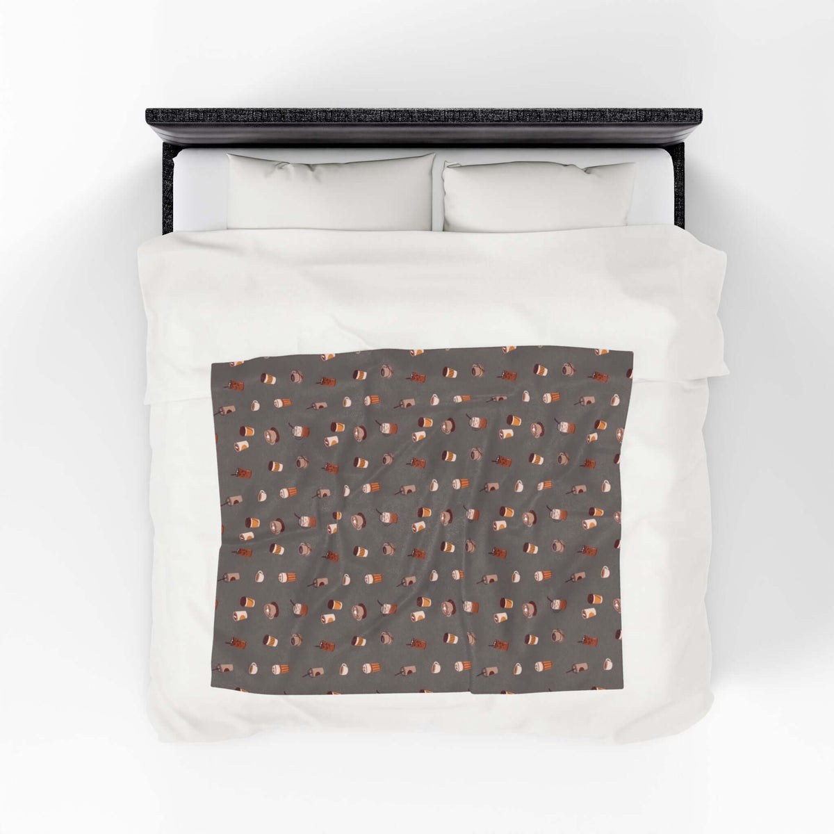 The Daily Grind Coffee Lovers Lightweight Cozy Blanket design with coffee cups on a comfy bedspread.
