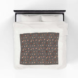 The Daily Grind Coffee Lovers Lightweight Cozy Blanket design with coffee cups on a comfy bedspread.