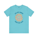 Do No Harm, Take No Sh!t premium soft tee in teal with bold peace flower design.
