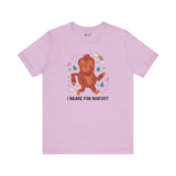 I Brake for Bigfoot Premium Soft Tee featuring a playful Sasquatch graphic on a lavender shirt.