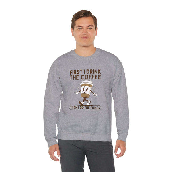 Gray sweatshirt featuring the quote 'First I Drink the Coffee Then I Do the Things' with a coffee cup graphic.