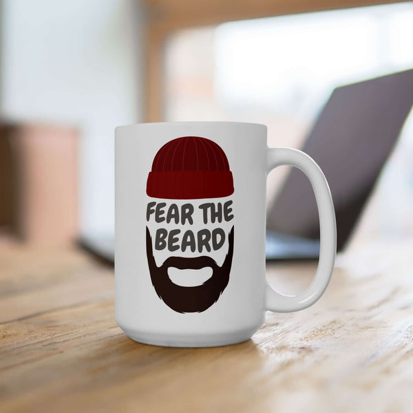 Fear the Beard mug featuring a bearded man in a red hat on a rustic wooden table.