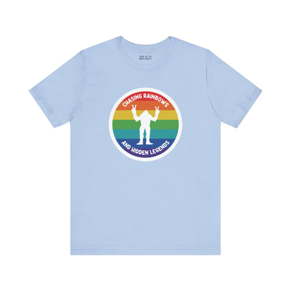 Chasing Rainbows Sasquatch Soft Tee Celebrate your roots with a splash of color and a touch of mystery in our "Hometown Pride" tee. Featuring a vibrant rainbow circle and a playful Sasquatch graphic, this shirt embodies the unique and spirited vibe of the