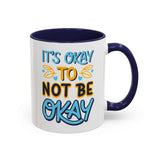 It's Okay To Not Be Okay Mug with colorful hand-lettered design and navy blue handle and interior.