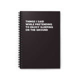 Spiral notebook with text: 'Things I Said While Pretending to Enjoy Sleeping on the Ground' for outdoor enthusiasts.