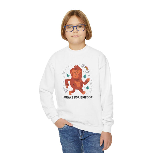 Child wearing white sweatshirt with 'I Brake for Bigfoot' design, perfect for adventurous kids.