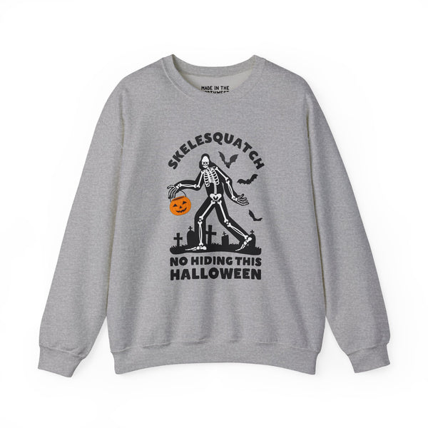 Skelesquatch Halloween sweatshirt featuring a skeleton Sasquatch with a pumpkin in a graveyard design.