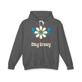 Stay Groovy hoodie featuring a cheerful daisy with peace signs on a dark gray sweatshirt.