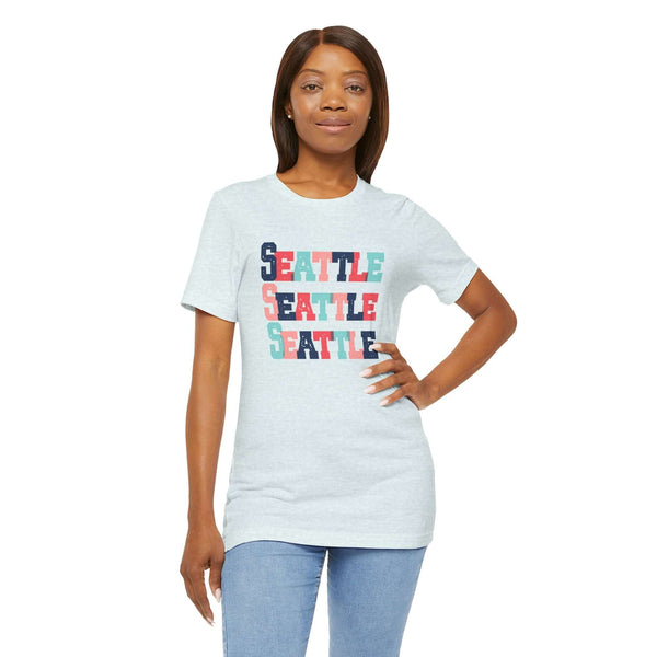 Woman wearing Seattle Trio Soft Tee with colorful block-letter design, perfect for showing love for Seattle and adding vibrancy to wardrobe.