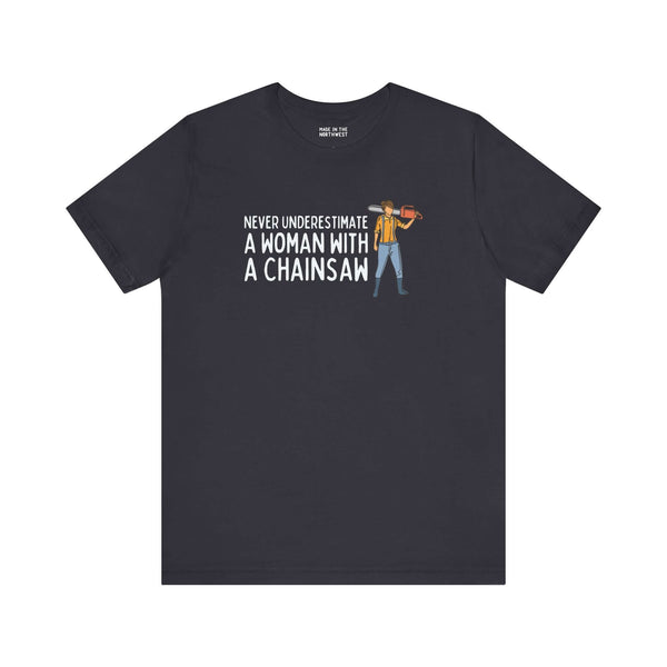 Premium soft tee with the phrase 'Never Underestimate a Woman with a Chainsaw' featuring an illustration of a woman.