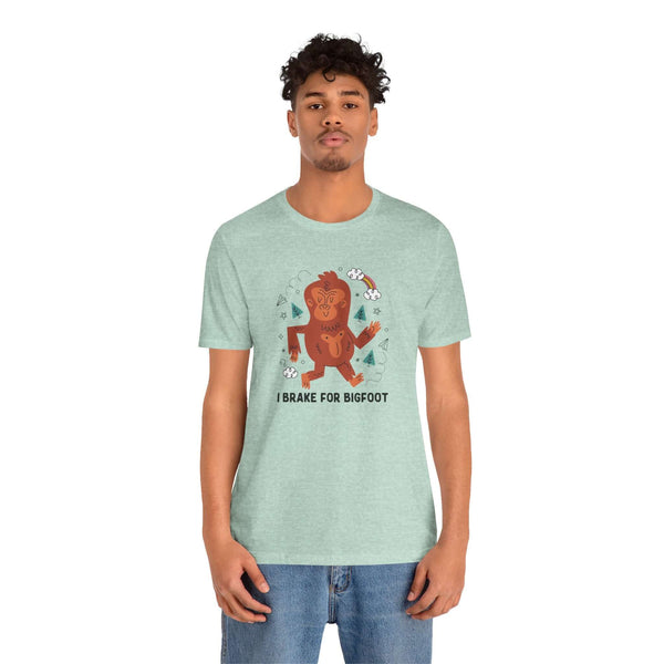 I Brake for Bigfoot premium soft tee featuring a whimsical Sasquatch graphic on a mint green shirt.