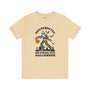 Skelesquatch Halloween premium soft tee featuring a skeleton with a pumpkin, graveyard, and bats design.