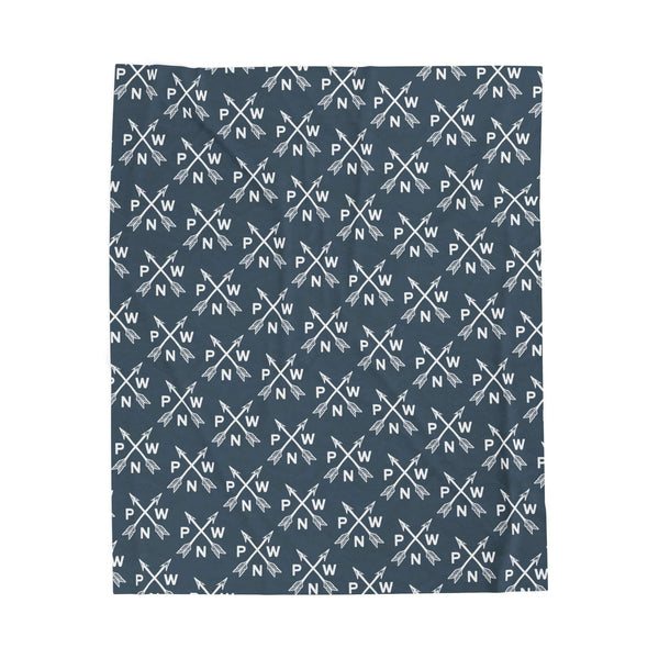 PNW blanket featuring a pattern of crossed arrows and PNW initials, perfect for cozy comfort and adventure.