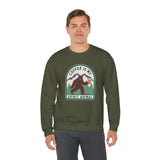 Man wearing a green sweatshirt with Sasquatch holding coffee and text 