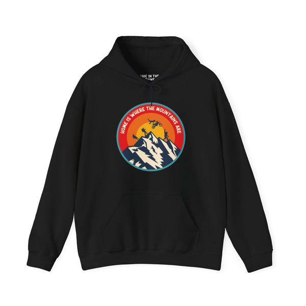 Black hoodie with "Home is Where the Mountains Are" design featuring mountains, motocross, hiking, and Bigfoot under a colorful circle.