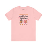 Support Your Local Caffeine Dealer coffee soft tee in pink featuring fun coffee cup and donut graphics.