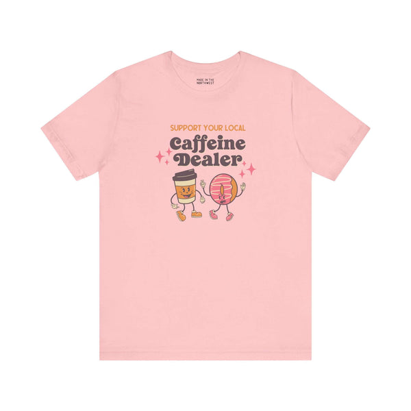 Support Your Local Caffeine Dealer coffee soft tee in pink featuring fun coffee cup and donut graphics.