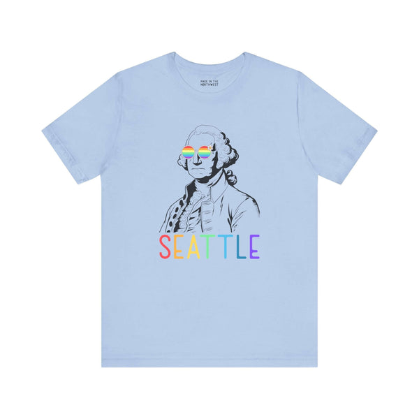 Light blue tee with George Washington in rainbow glasses and "Seattle" in rainbow letters, celebrating Pride and inclusivity.