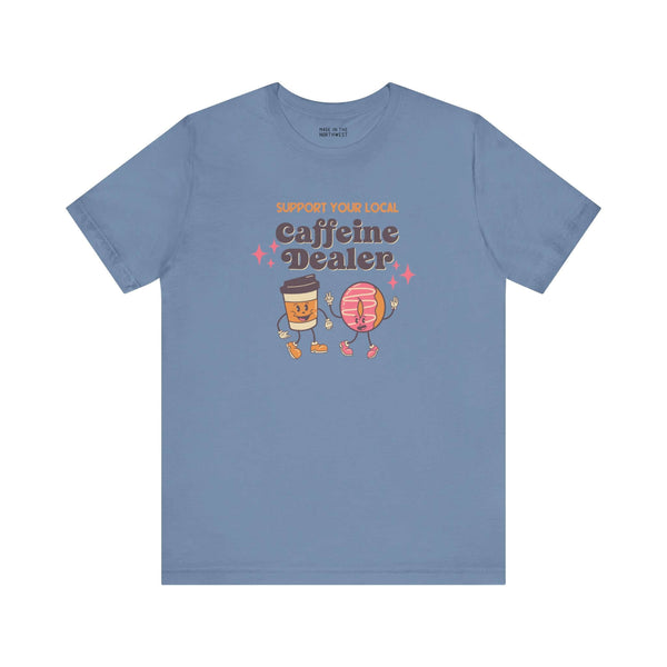 Support Your Local Caffeine Dealer coffee soft tee in blue, featuring playful coffee cup and donut graphics.
