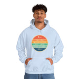 Man wearing Tacoma Edition hoodie with Left Coast circular logo in colorful design.