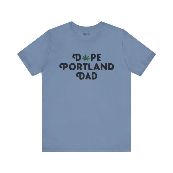 Blue "Dope Portland Dad" tee with marijuana leaf design, celebrating fatherhood and PDX pride.