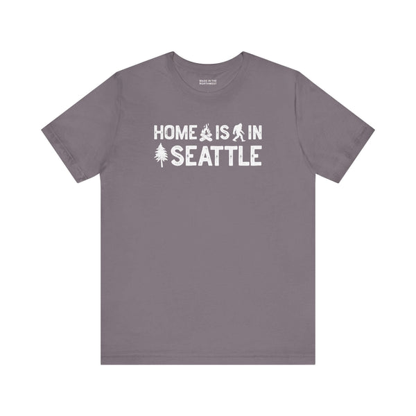 Home Is in Seattle Tee featuring campfire, Bigfoot, and tree designs celebrating Seattle pride.