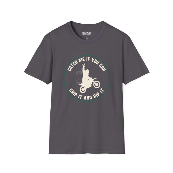 Gray softstyle t-shirt featuring a Bigfoot motocross design with the text 'Catch Me If You Can, Grip It and Rip It'.