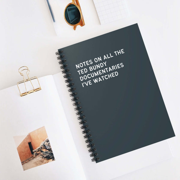 Spiral notebook with notes on Ted Bundy documentaries, ideal for true crime enthusiasts and researchers.
