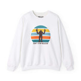 Don't Stop Believin' Bigfoot sweatshirt featuring a playful sasquatch graphic and colorful stripes.