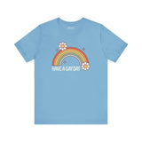 Have a Gay Day T Shirt featuring a colorful rainbow and flowers on a light blue background.