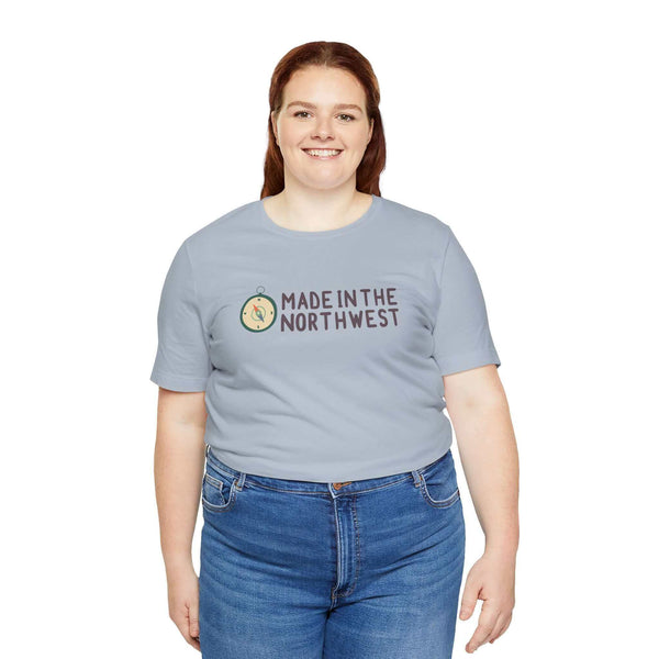 Woman wearing Made in the Northwest original logo soft tee with compass design, symbolizing Pacific Northwest pride and adventure.