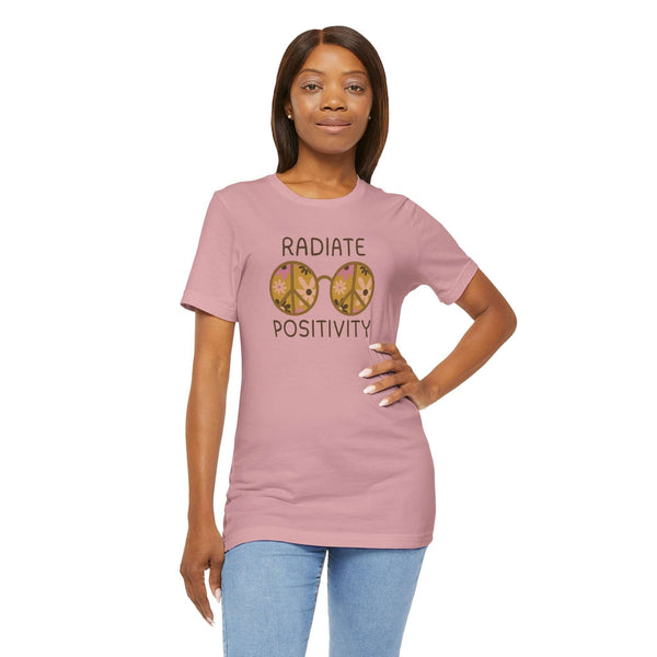 Model wearing Radiate Positivity Premium Soft Tee with floral glasses design in soft pink color.