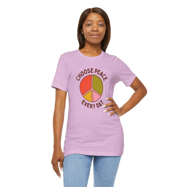 Model wearing a purple Choose Peace Every Day tee with a colorful peace symbol design.