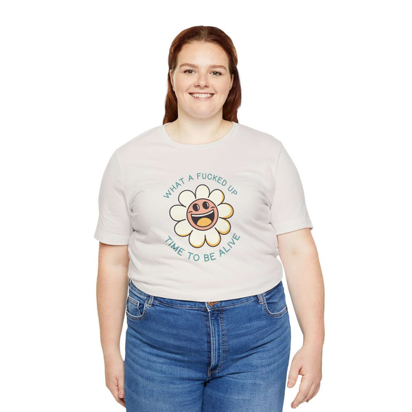 Woman wearing What a F*cked Up Time to Be Alive Premium Soft Tee with a smiling daisy design.